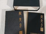 trois livres noirs posés les uns à côté des autres sur une table
