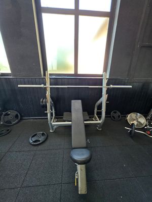 a gym room with a bench, weights, and other equipment