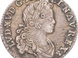 gros plan d'une pièce de monnaie sur laquelle figure une tête de femme