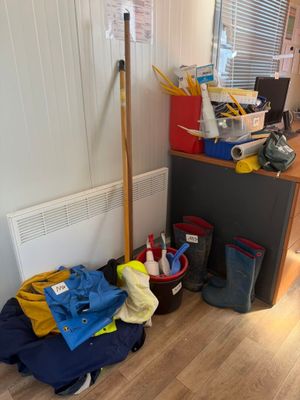 a pile of clothes on the floor next to a radiator