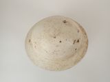 a white bowl on a table with a white background