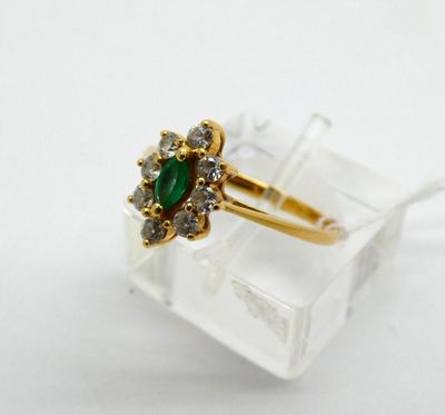 an image of a gold ring with a green stone surrounded by white diamonds