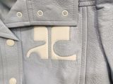 the back of a light blue jacket with a white logo on it