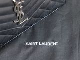 a close up of a black jacket with a saint laurent logo on it