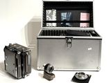 a silver box with a camera and some other items