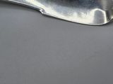 silver spoon on a gray surface with a black background