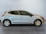 the silver car is parked in a room with a gray floor