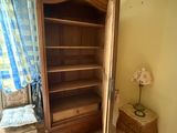 a large wooden cabinet in the corner of a room