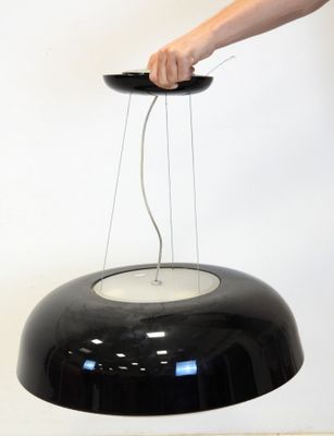 a person that is holding a black object in their hand