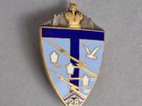 a close up of a blue and white shield with a crown on top