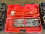 a red tool box with tools in it on the floor