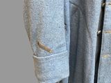 the back of a blue coat with buttons on a mannequin mannequin mannequin mannequin mannequin mannequin mannequin mann
