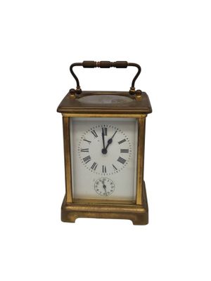 l'image d'une petite horloge dont le cadran comporte des chiffres romains