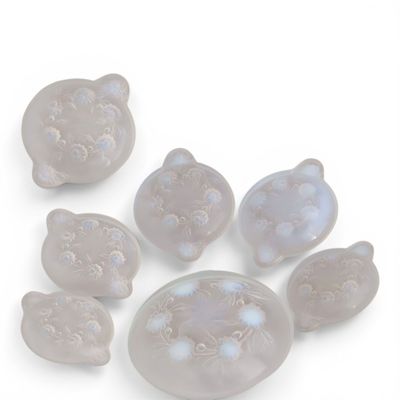 a picture of a group of glass cats on a white surface