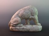 a statue of a bear on a rock on a table