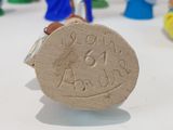 a close up of a wooden coin on a table