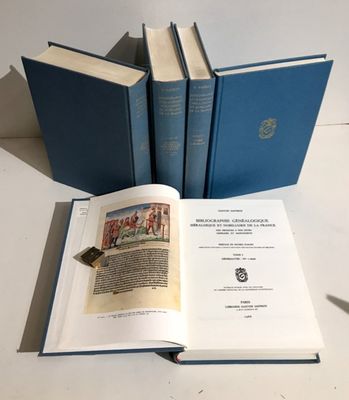 three blue books sitting on top of a table next to each other