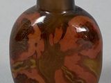 a brown vase with a green lid sitting on a table