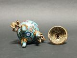a small blue and gold vase next to a smaller gold vase