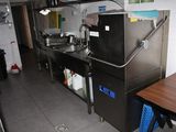 a kitchen with a sink, stove, and a refrigerator in it