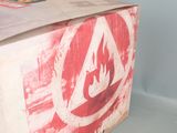 a cardboard box with a red and white fire symbol on it