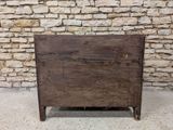 an old wooden chest sitting in front of a stone wall
