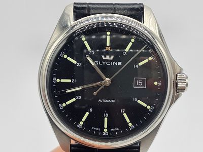 a close up of a wrist watch with a black dial