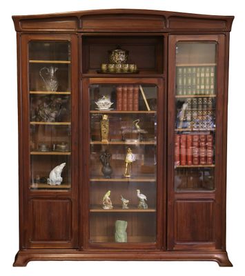 a wooden cabinet with glass doors and a clock on top of it