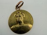 a close up of a gold medal on a white surface