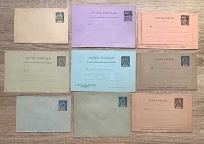 six envelopes of different colors and sizes on a wooden table