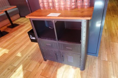 une table en bois sur laquelle est posé un meuble en métal