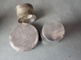 a silver cup and a silver container on a table