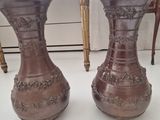 two vases that are sitting on a table