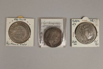 Trois types différents de pièces d'argent sont exposés dans de petits emballages