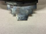 a close up of a metal object on a white surface