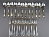 an assortment of silverware including spoons, forks and spoons
