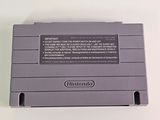 an old nintendo game console sitting on top of a white table