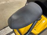 a close up of a seat on a yellow scooter