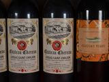 several bottles of wine are lined up on a shelf