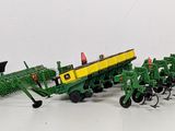 a lot of toy farm equipment on a white surface