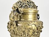brass incense burner with a monkey on the top of it