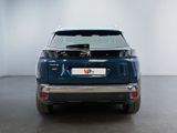 the rear end of a blue suv parked in a white room