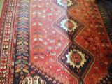 an image of a large oriental rug on the floor in a living room