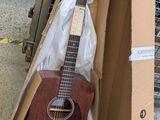 a guitar that is in a box on the floor