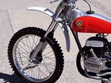 a red and white dirt bike parked on the side of the road