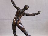 statue of a man holding a tennis racquet on a marble base