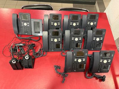 a lot of phones that are sitting on a red table