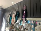 many different items hanging on the wall in the store