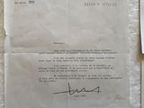 an old letter is on a piece of paper next to a piece of paper