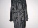 grey bathrobe on a mannequin stand against a white wall